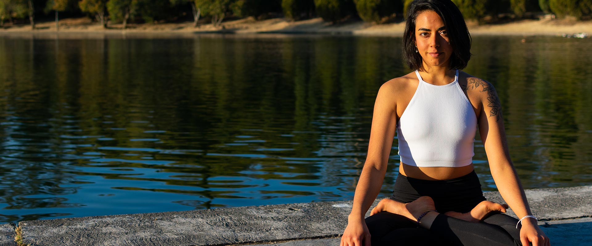 Mindful yoga practice by river in nature